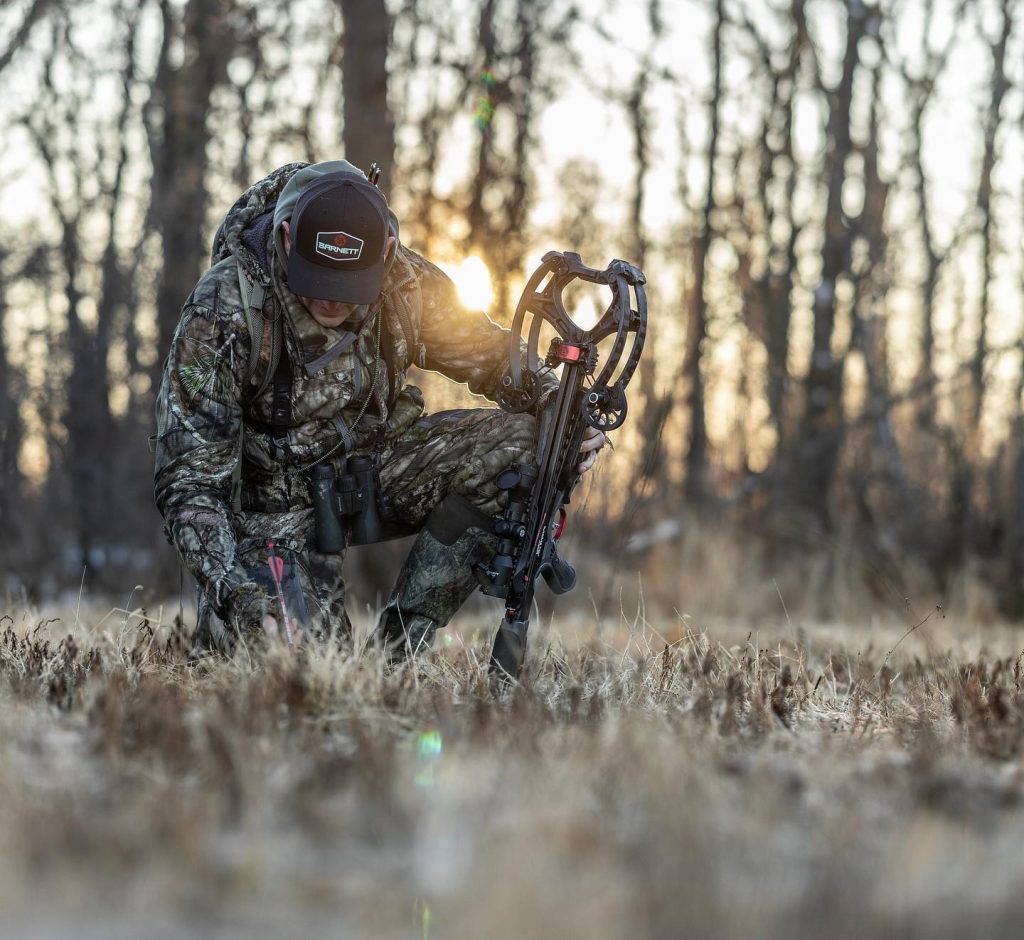 Man with a crossbow in a field
