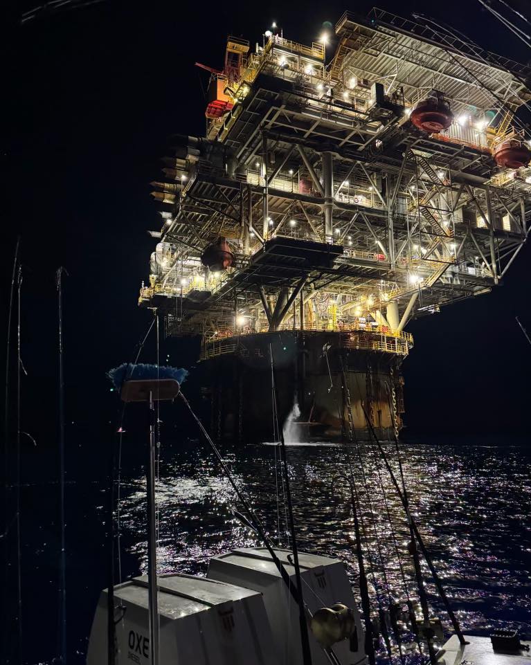 fishing under an oil rig